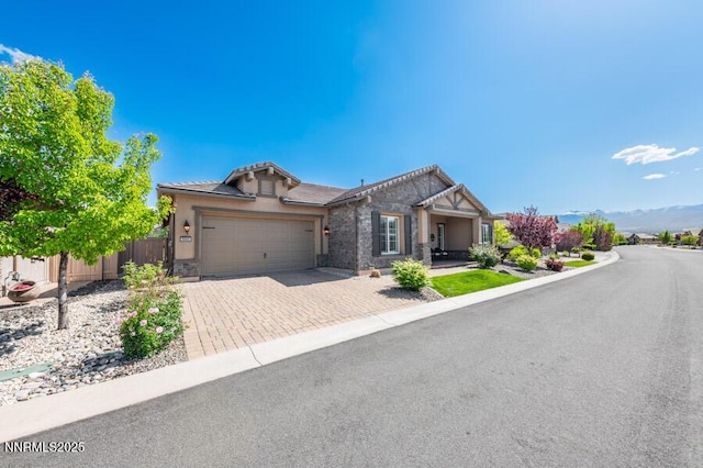 9800 Hafflinger Ln, Reno, NV 89521 - ranch-style home with an attached garage, decorative driveway, stucco siding, and a tiled roof