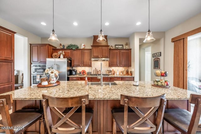 9800 Hafflinger Ln, Reno, NV 89521 - kitchen with stainless steel appliances, tasteful backsplash, a large island with sink, decorative light fixtures, and recessed lighting