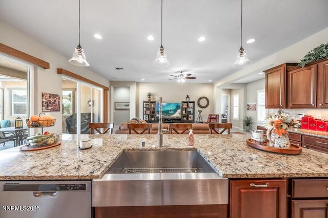 9800 Hafflinger Ln, Reno, NV 89521 - kitchen with stainless steel dishwasher, open floor plan, a sink, a ceiling fan, and decorative light fixtures