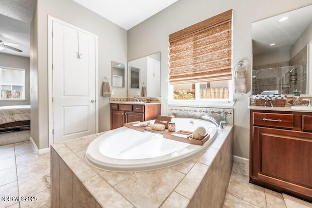 9800 Hafflinger Ln, Reno, NV 89521 - full bathroom with vanity, a shower stall, a garden tub, and tile patterned flooring