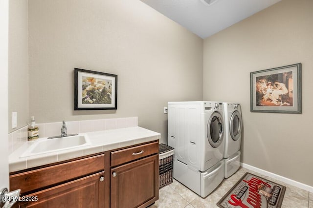 9800 Hafflinger Ln, Reno, NV 89521 - laundry area featuring washing machine and dryer, cabinet space, light tile patterned floors, and baseboards