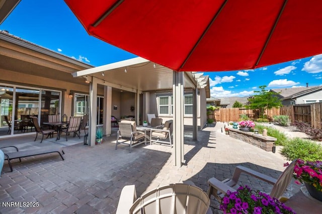 9800 Hafflinger Ln, Reno, NV 89521 - fenced backyard featuring a patio area and an outdoor living space
