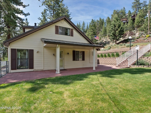 605 Jerry Dr, Zephyr Cove, NV 89448 - back of property with a standing seam roof, a patio, metal roof, and stairs