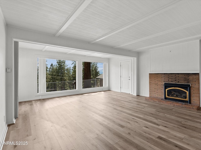 605 Jerry Dr, Zephyr Cove, NV 89448 - unfurnished living room featuring beam ceiling, light wood-style floors, and a brick fireplace