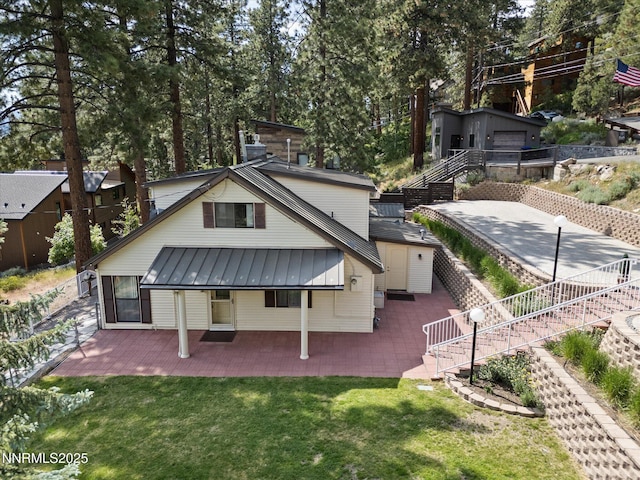 605 Jerry Dr, Zephyr Cove, NV 89448 - back of house with stairs, metal roof, a standing seam roof, and a yard