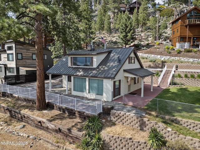 605 Jerry Dr, Zephyr Cove, NV 89448 - chalet / cabin with a metal roof, a fenced backyard, and a patio area