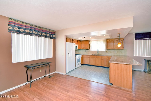 35 Count Fleet Ct, Reno, NV 89502 - kitchen featuring white appliances, a peninsula, light wood-style floors, and tasteful backsplash