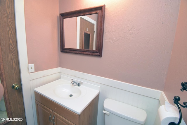 35 Count Fleet Ct, Reno, NV 89502 - half bathroom with wainscoting, vanity, and a decorative wall