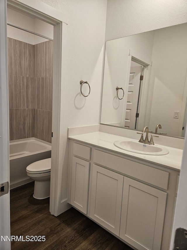 1224 Heybourne Rd, Gardnerville, NV 89410 - bathroom featuring toilet, wood finished floors, vanity, and shower / bathtub combination