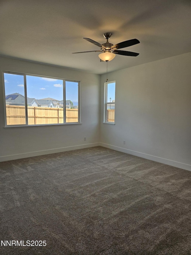 1224 Heybourne Rd, Gardnerville, NV 89410 - empty room featuring a ceiling fan, dark colored carpet, and baseboards
