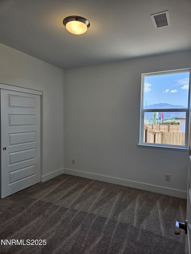 1224 Heybourne Rd, Gardnerville, NV 89410 - spare room featuring dark colored carpet and baseboards