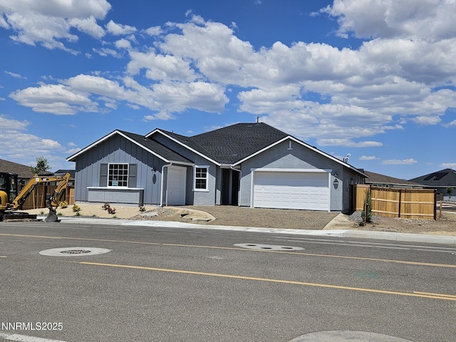 1224 Heybourne Rd, Gardnerville, NV 89410 - ranch-style house featuring board and batten siding, an attached garage, and driveway
