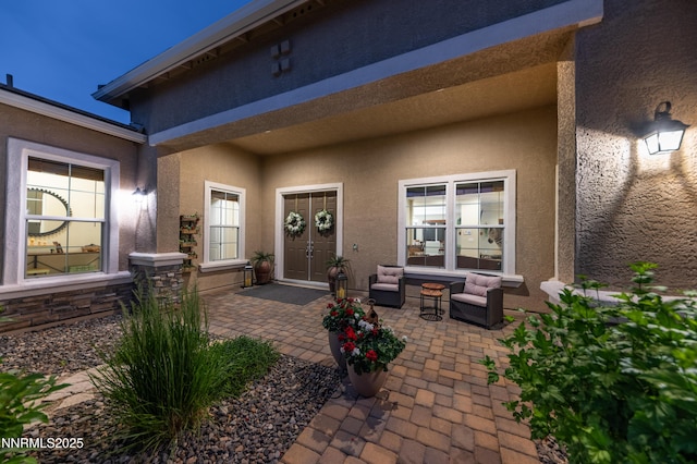 9860 Sea Breeze Ln, Reno, NV 89521 - view of exterior entry with stucco siding and a patio area