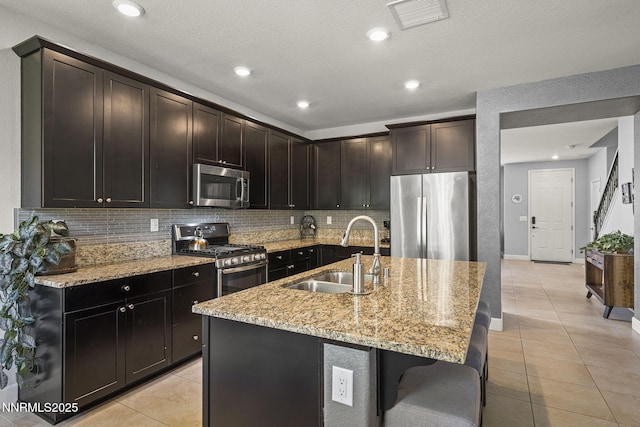 1775 Samantha Crest Trl, Reno, NV 89523 - kitchen featuring stainless steel appliances, light tile patterned flooring, tasteful backsplash, light stone countertops, and recessed lighting