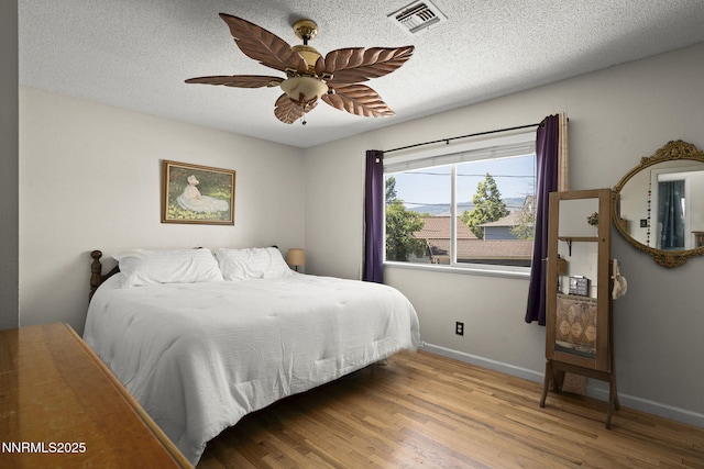 3505 Everett Dr, Reno, NV 89503 - bedroom with wood finished floors, a ceiling fan, and a textured ceiling