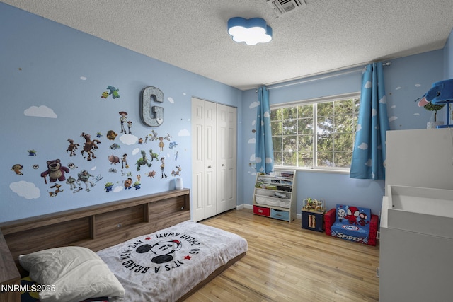 3505 Everett Dr, Reno, NV 89503 - bedroom with a textured ceiling, a closet, and wood finished floors