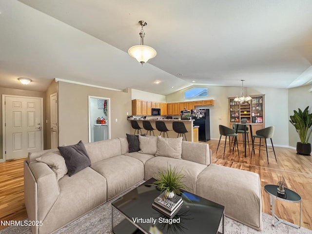 2657 Elizabeth Pkwy, Fallon, NV 89406 - living room featuring a chandelier, lofted ceiling, light wood-type flooring, baseboards, and recessed lighting