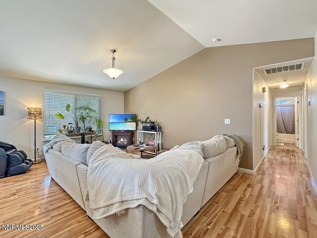 2657 Elizabeth Pkwy, Fallon, NV 89406 - living room featuring light wood finished floors, vaulted ceiling, and baseboards