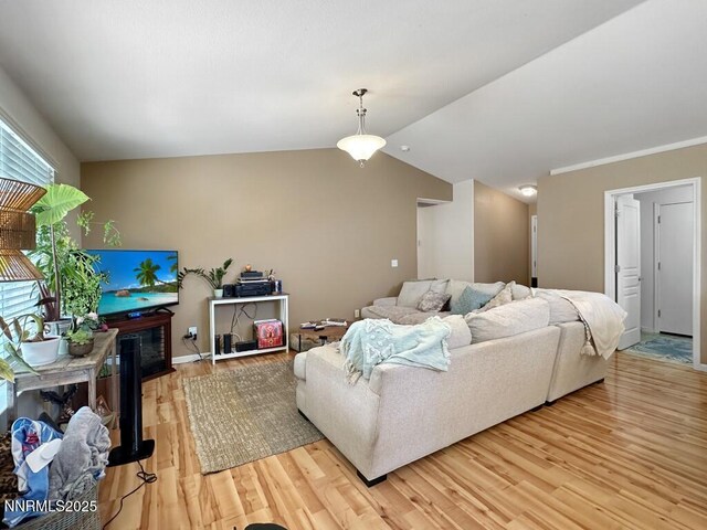 2657 Elizabeth Pkwy, Fallon, NV 89406 - living room featuring light wood finished floors, vaulted ceiling, and baseboards