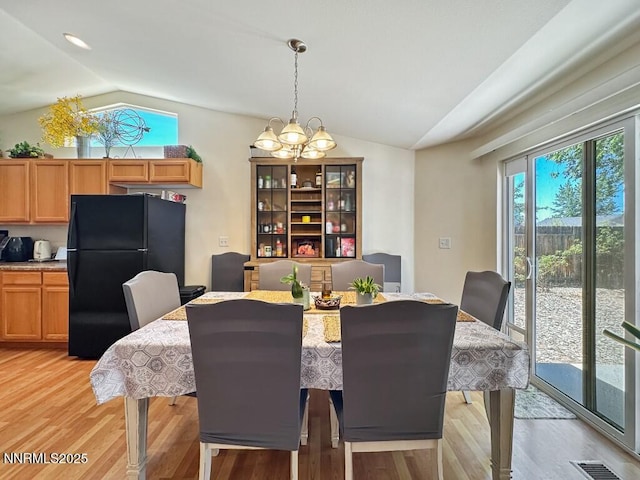2657 Elizabeth Pkwy, Fallon, NV 89406 - dining space with lofted ceiling, light wood-style floors, and a chandelier