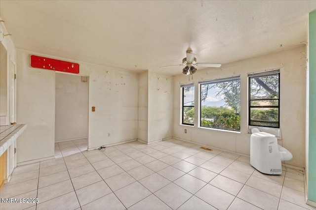 1372 Laser Ct, Sparks, NV 89436 - unfurnished room with ceiling fan, light tile patterned floors, and a textured ceiling