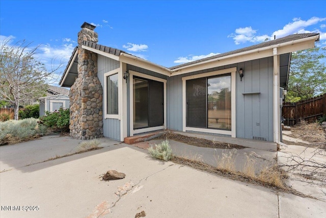 1372 Laser Ct, Sparks, NV 89436 - back of property featuring a chimney, a patio, and board and batten siding