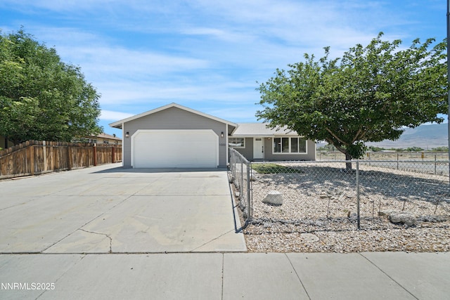 1000 Dwight Way, Dayton, NV 89403 - view of front facade with concrete driveway, a fenced front yard, and a garage