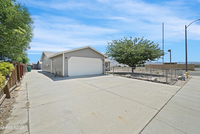 1000 Dwight Way, Dayton, NV 89403 - view of side of property featuring a garage and concrete driveway