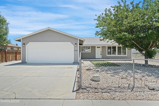 1000 Dwight Way, Dayton, NV 89403 - ranch-style home with an attached garage, concrete driveway, and a fenced front yard