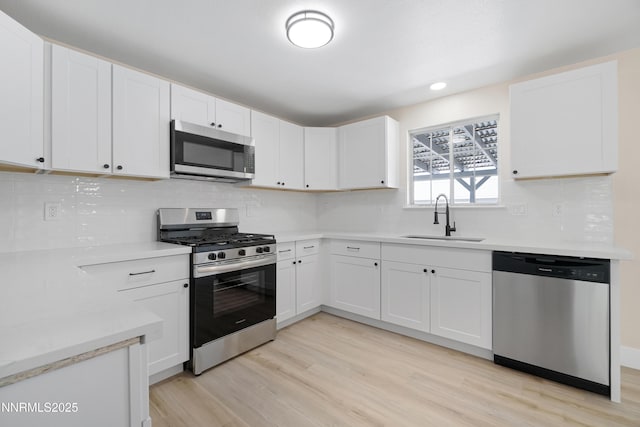 1000 Dwight Way, Dayton, NV 89403 - kitchen featuring appliances with stainless steel finishes, a sink, light wood-type flooring, light countertops, and recessed lighting