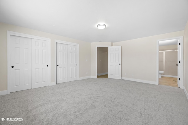 1000 Dwight Way, Dayton, NV 89403 - unfurnished bedroom featuring carpet floors, multiple closets, baseboards, and ensuite bath