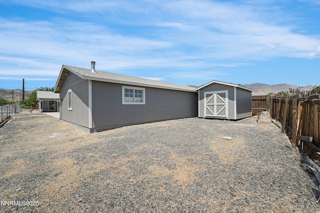 1000 Dwight Way, Dayton, NV 89403 - rear view of house featuring a fenced backyard and a mountain view