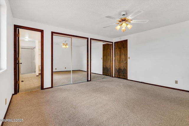 1809 Franklin Rd, Carson City, NV 89706 - unfurnished bedroom featuring multiple closets, carpet, connected bathroom, a textured ceiling, and baseboards