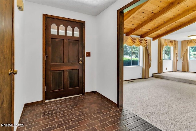 1809 Franklin Rd, Carson City, NV 89706 - foyer with brick patterned flooring, baseboards, and beam ceiling