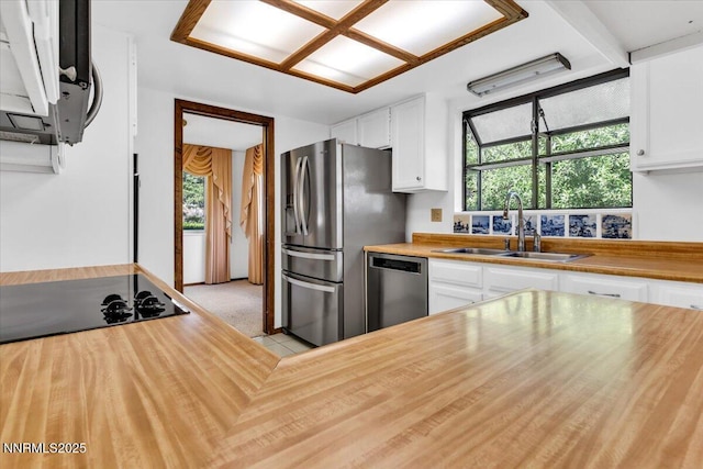 1809 Franklin Rd, Carson City, NV 89706 - kitchen with stainless steel appliances, a sink, butcher block countertops, and white cabinetry