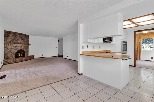 1809 Franklin Rd, Carson City, NV 89706 - kitchen featuring stainless steel appliances, light carpet, white cabinets, and light tile patterned floors