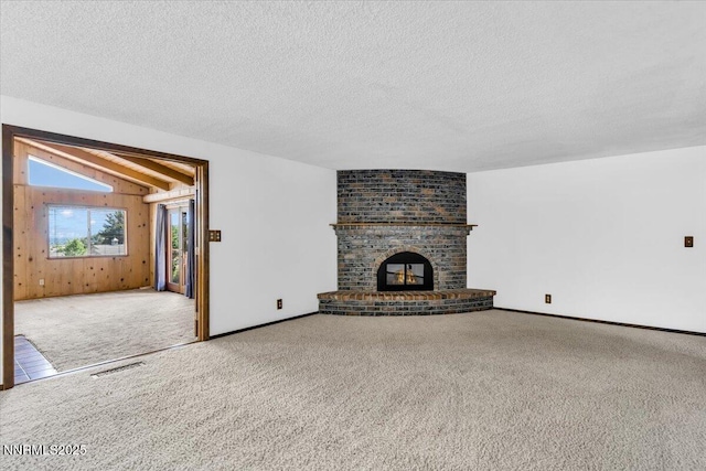 1809 Franklin Rd, Carson City, NV 89706 - unfurnished living room featuring carpet flooring, vaulted ceiling, a textured ceiling, a fireplace, and baseboards