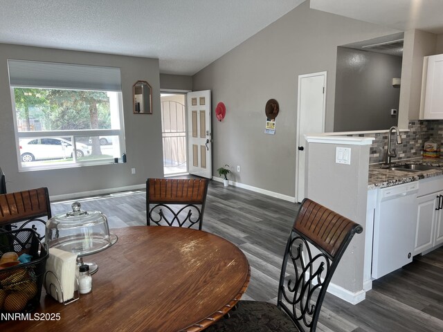 7785 Crystal Shores Dr, Reno, NV 89506 - dining space featuring dark wood-type flooring and vaulted ceiling