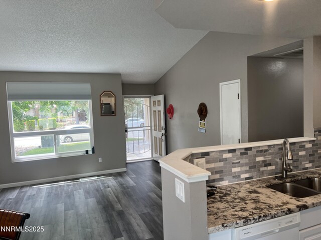 7785 Crystal Shores Dr, Reno, NV 89506 - kitchen featuring white dishwasher, tasteful backsplash, light stone counters, and a textured ceiling