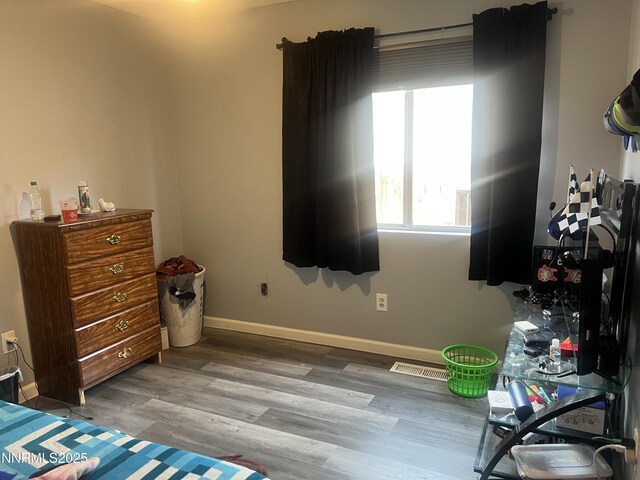 7785 Crystal Shores Dr, Reno, NV 89506 - bedroom featuring multiple windows and wood finished floors