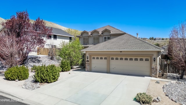 2978 Fox Trail Dr, Reno, NV 89523 - view of front of house with driveway, an attached garage, roof with shingles, and stone siding