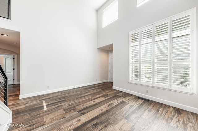 2978 Fox Trail Dr, Reno, NV 89523 - unfurnished living room featuring a towering ceiling, wood finished floors, and arched walkways