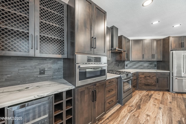 2978 Fox Trail Dr, Reno, NV 89523 - kitchen featuring stainless steel appliances, light countertops, light wood-style floors, dark brown cabinetry, and recessed lighting