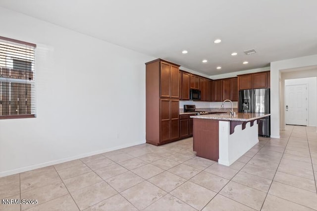 14373 Fredonia Dr, Reno, NV 89506 - kitchen featuring stainless steel fridge, black microwave, range, light tile patterned floors, and recessed lighting