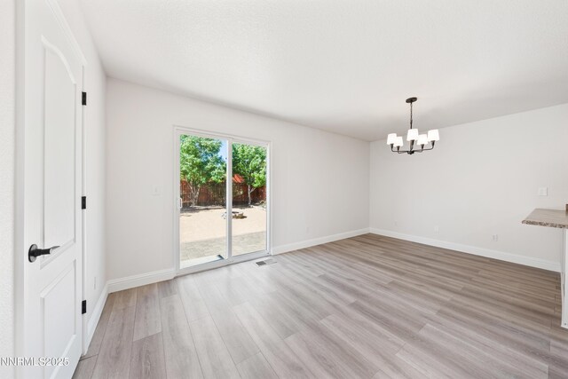 17705 Oakview Ct, Reno, NV 89508 - spare room with light wood-type flooring and a chandelier
