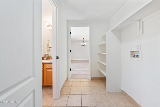 17705 Oakview Ct, Reno, NV 89508 - washroom featuring washer hookup, a chandelier, and light tile patterned floors