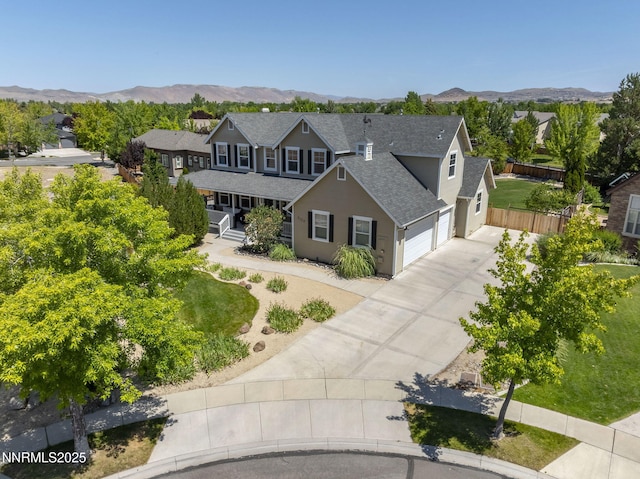3128 Wild Iris Ct, Sparks, NV 89436 - traditional-style home featuring a shingled roof, concrete driveway, a porch, a garage, and a mountain view