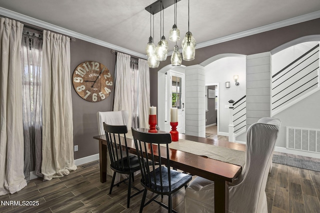 3128 Wild Iris Ct, Sparks, NV 89436 - dining area featuring arched walkways, wood finished floors, crown molding, stairs, and ornate columns