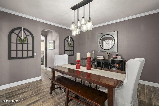 3128 Wild Iris Ct, Sparks, NV 89436 - dining area with arched walkways, wood finished floors, crown molding, and a chandelier