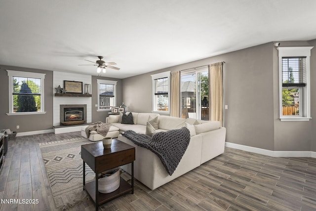 3128 Wild Iris Ct, Sparks, NV 89436 - living area featuring ceiling fan, healthy amount of natural light, dark wood-type flooring, and a fireplace